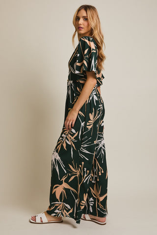 Woman wearing a floral dress against a plain background