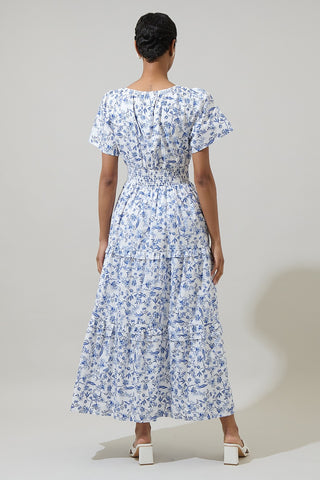 Woman wearing a floral dress against a plain background